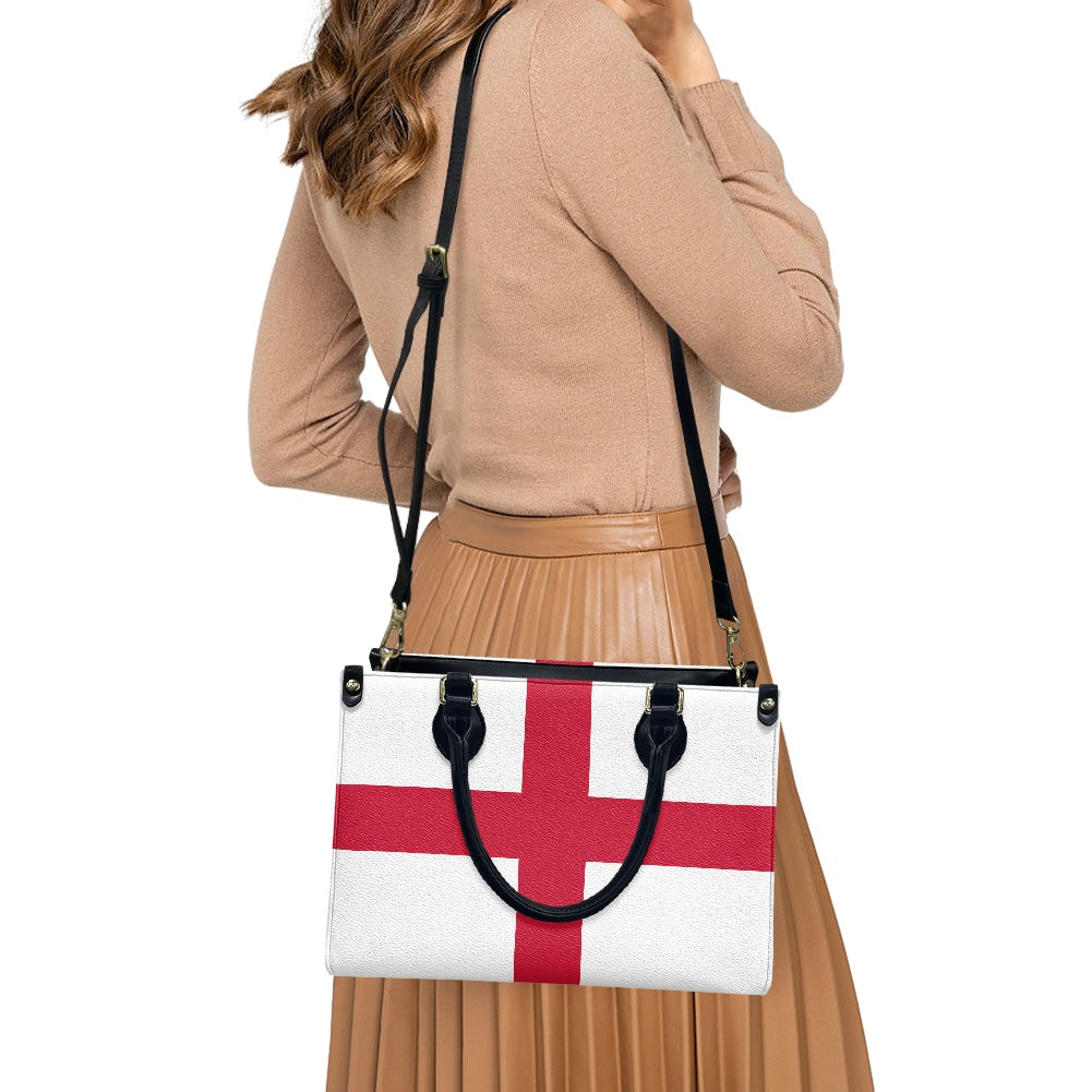 Woman carrying [Brand] bag with England flag design.