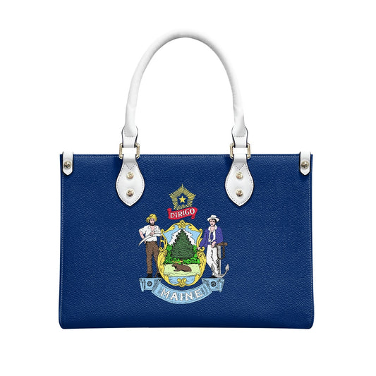 [Brand] handbag featuring Maine state flag design, white handles.