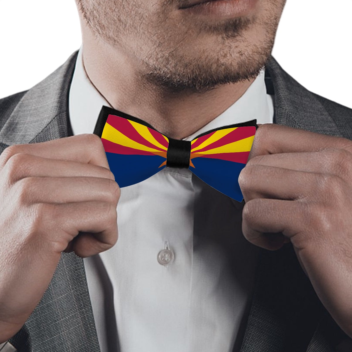 Man adjusting [Brand] bow tie with colorful Arizona flag design.
