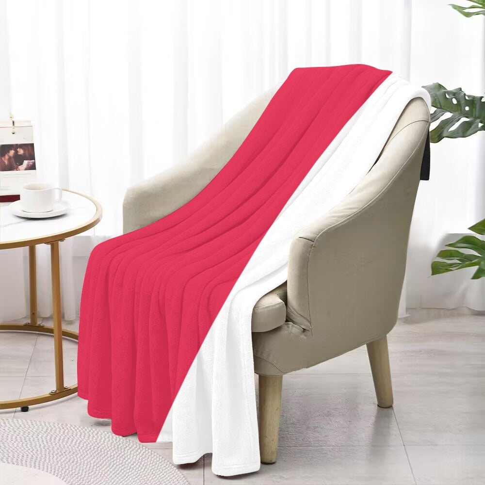 Luv My Flag blanket draped over beige armchair, indoors.