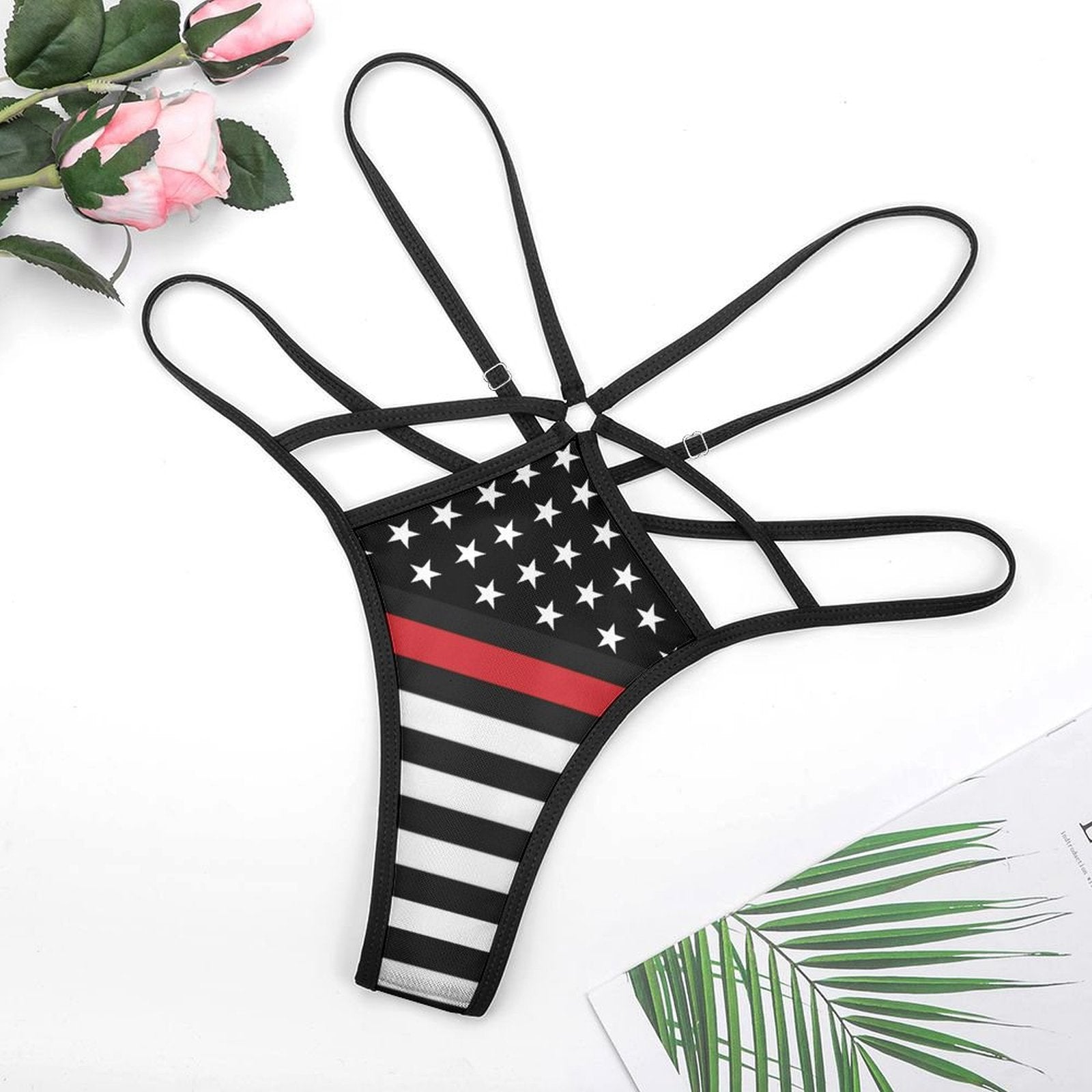 [Brand] strappy black and white thong with star pattern.