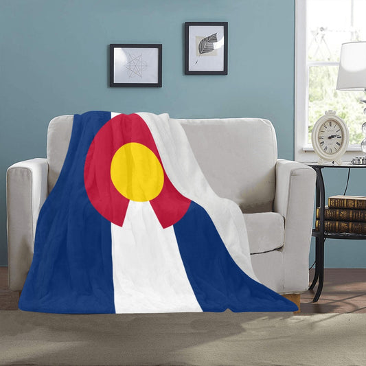 Cozy sofa featuring Luv My Flag's Colorado-themed blanket.
