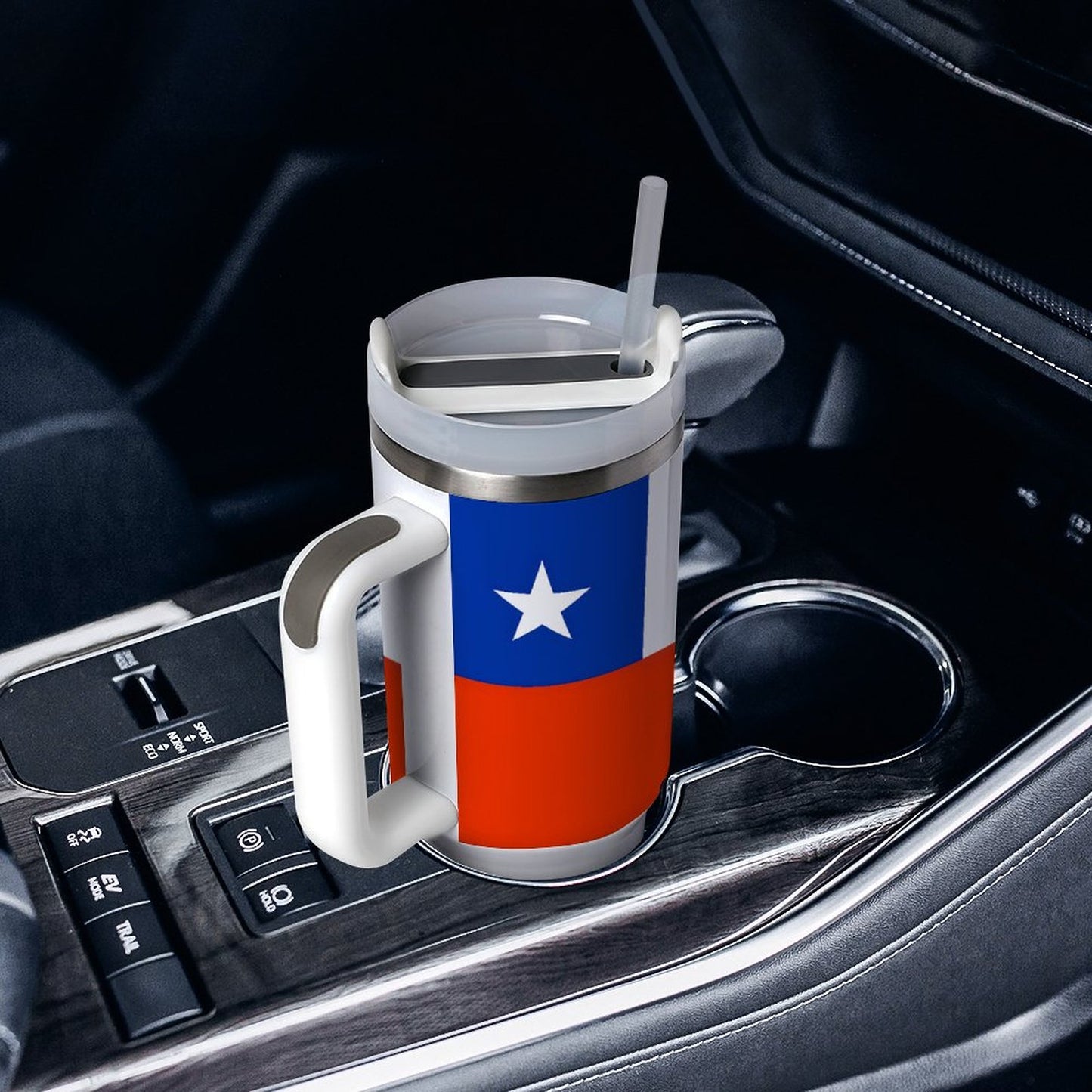Travel mug with flag design in car cup holder. [Brand]