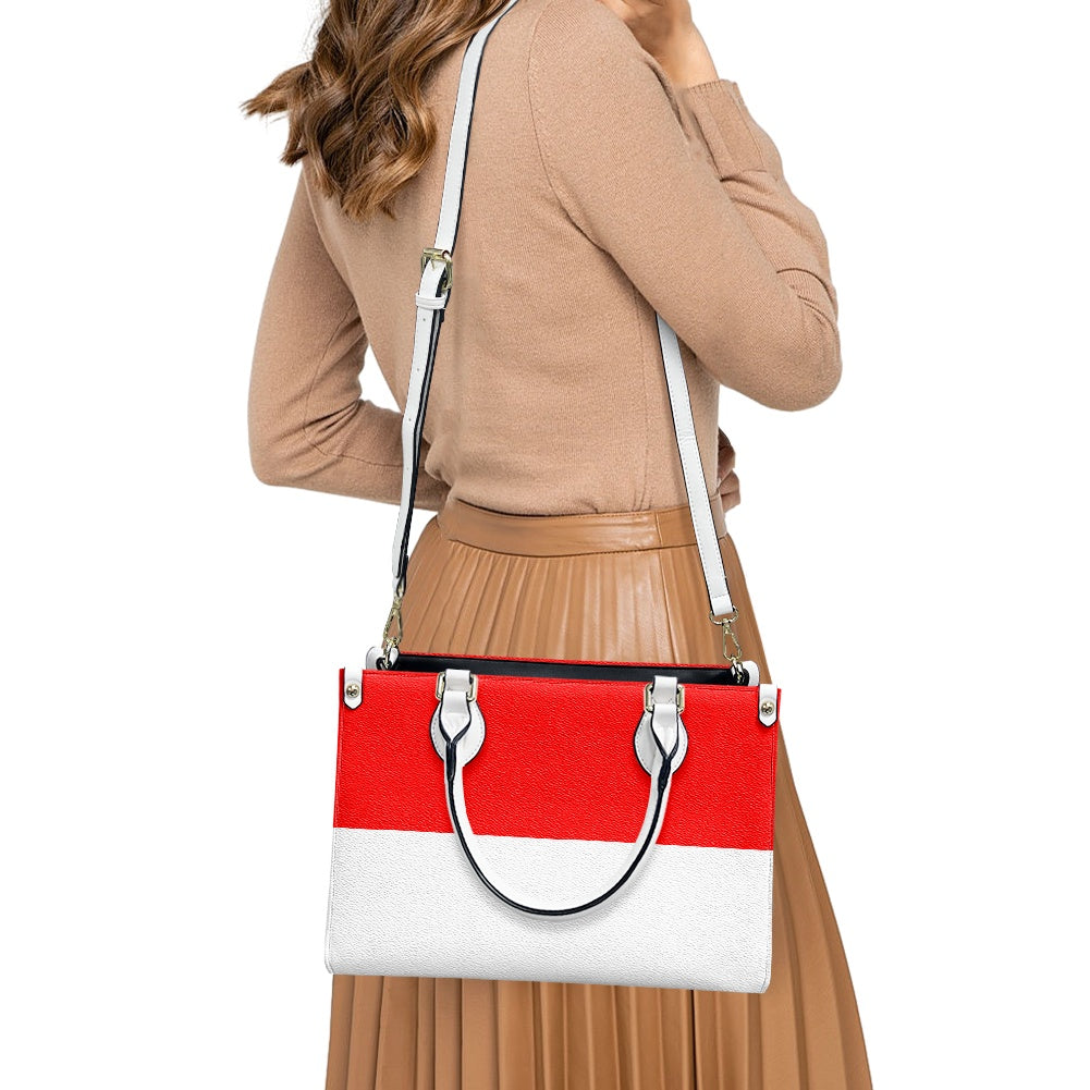 Woman carrying a [Brand] red and white handbag stylishly.