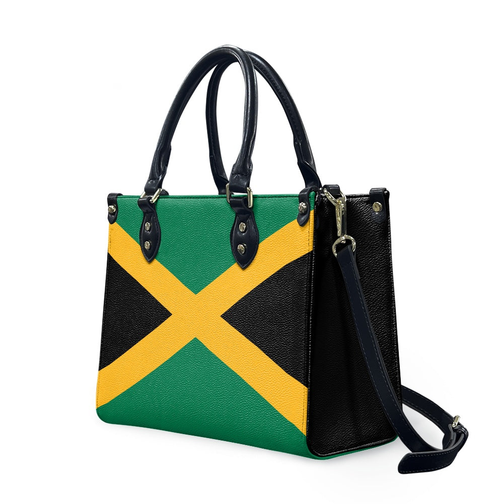 [Brand] handbag featuring a Jamaican flag design with straps.