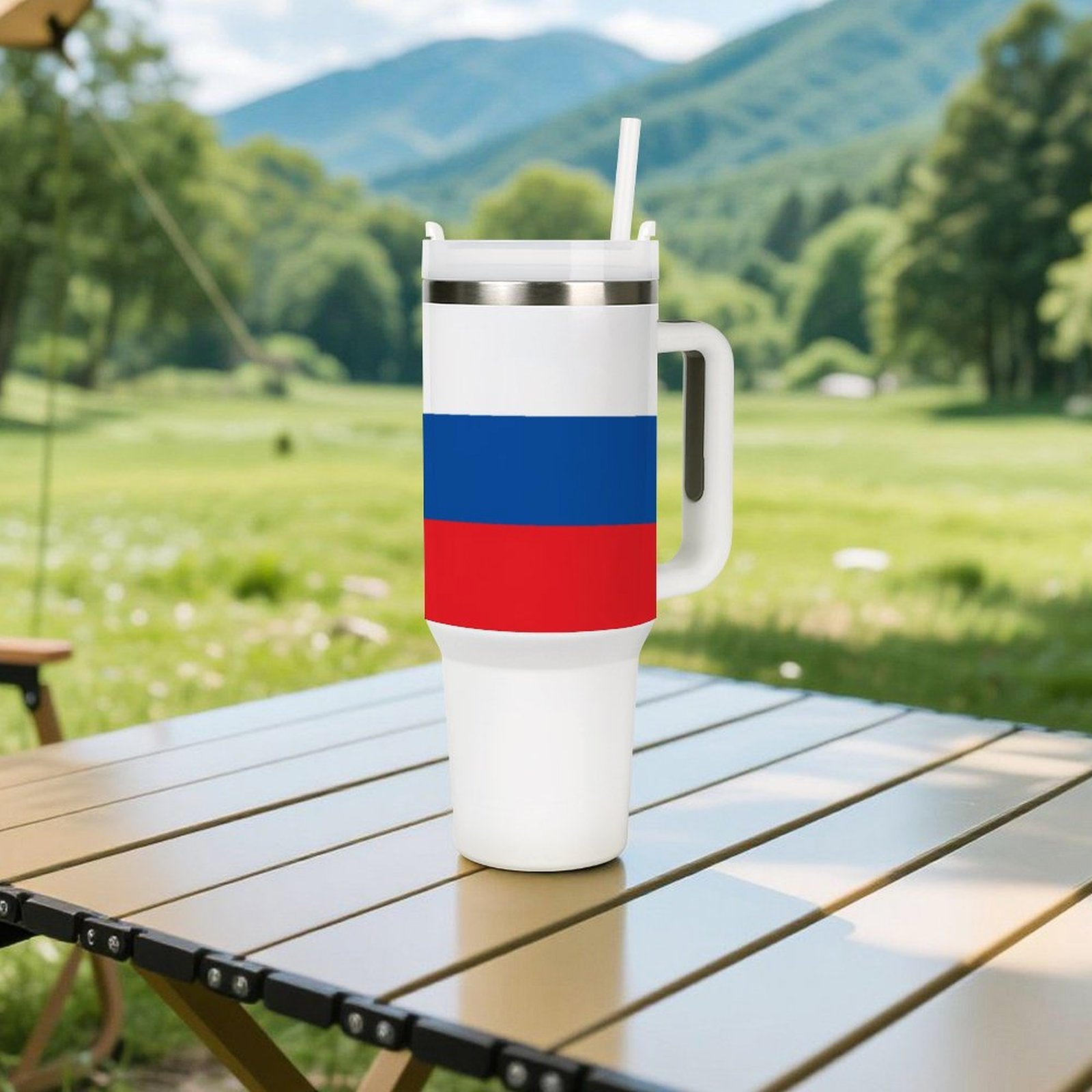 White [Brand] mug with blue and red bands outdoors.