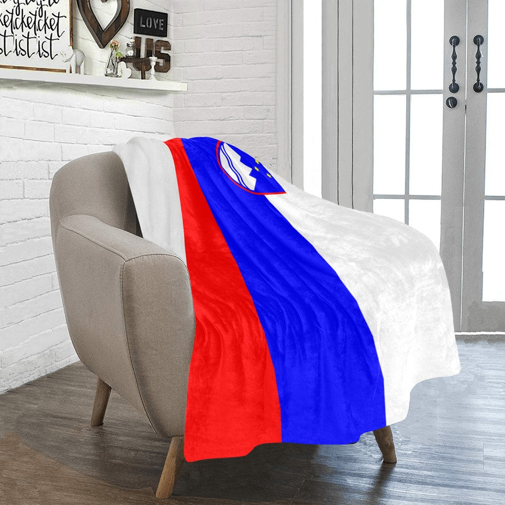 [Luv My Flag] blanket draped on chair, vibrant flag design.