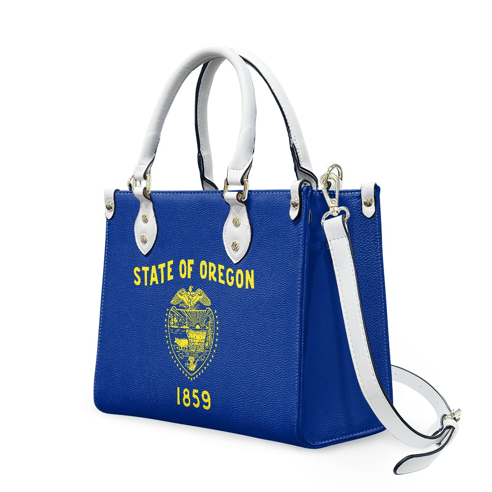 [Brand] blue handbag featuring State of Oregon emblem design.