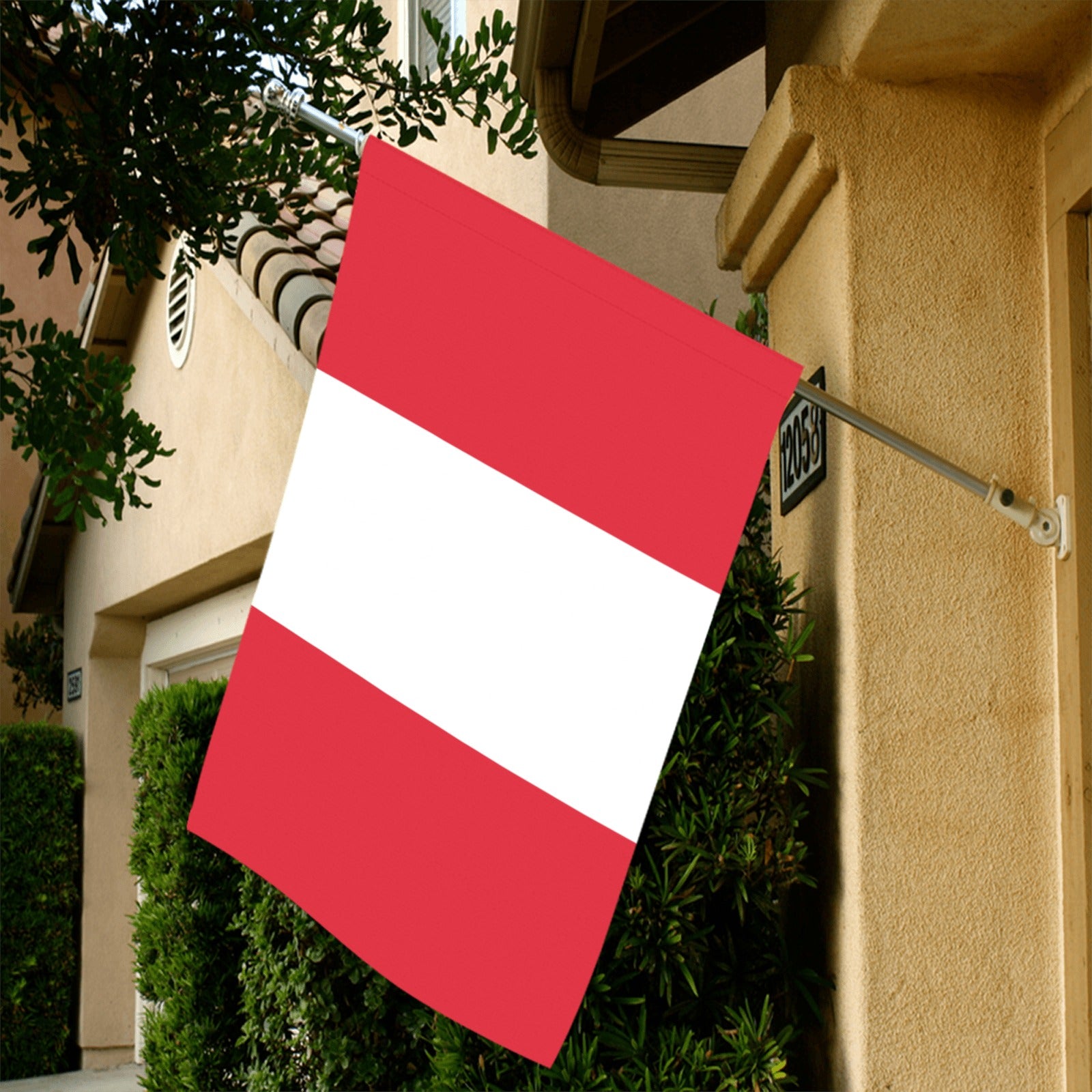 Red and white flag from Luv My Flag hanging outside.