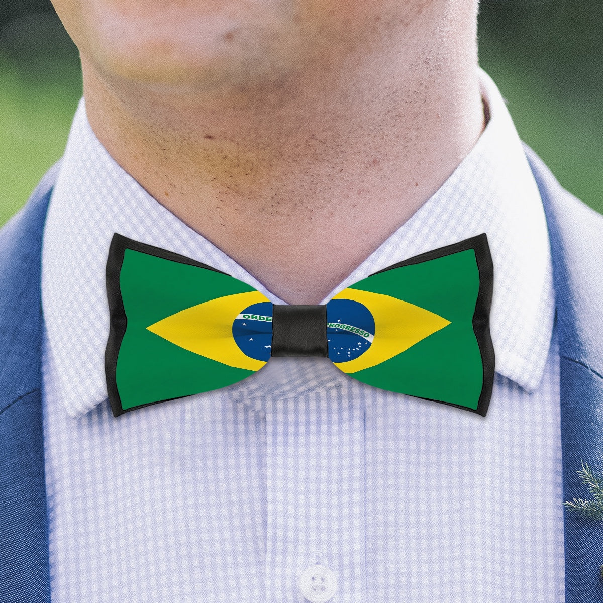 Person wearing Brazil flag bow tie, blue suit, [Brand].