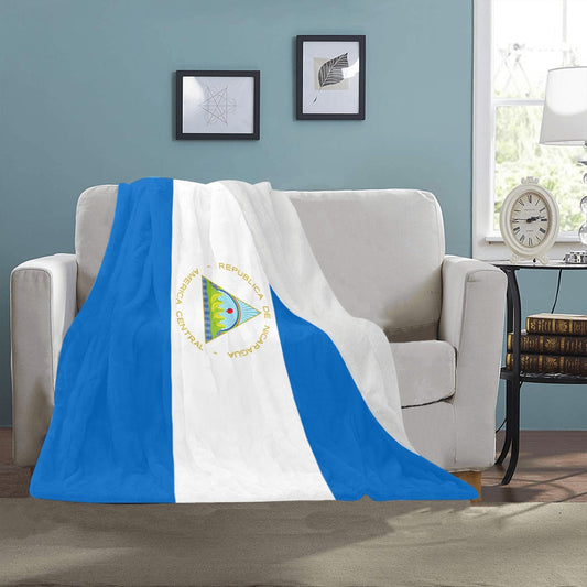 [Luv My Flag] blanket with Nicaraguan design on sofa.
