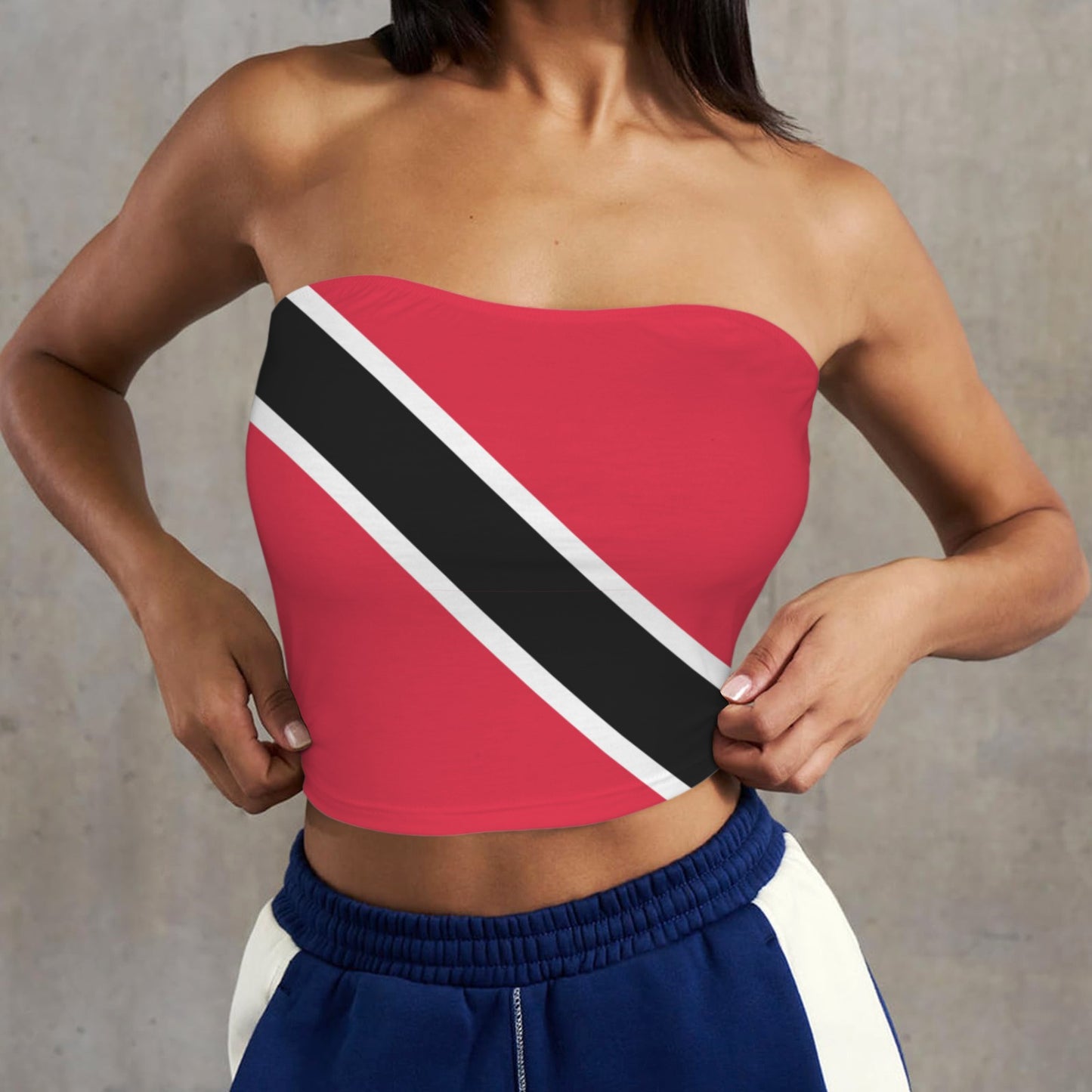 Woman wearing [Brand] flag-themed tube top and blue shorts.