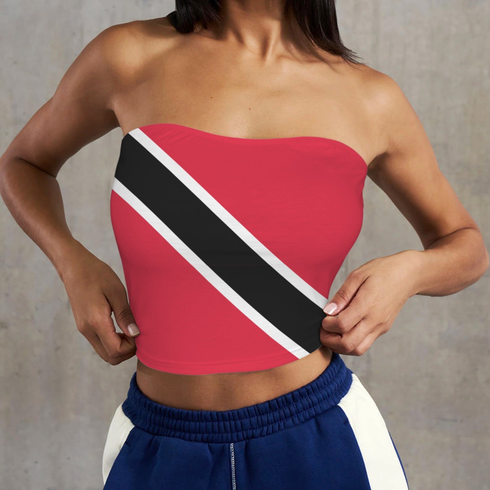 Woman wearing [Brand] flag-themed tube top and blue shorts.