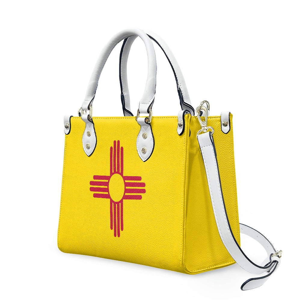 Yellow handbag with Zia symbol, featuring [Brand] design elements.