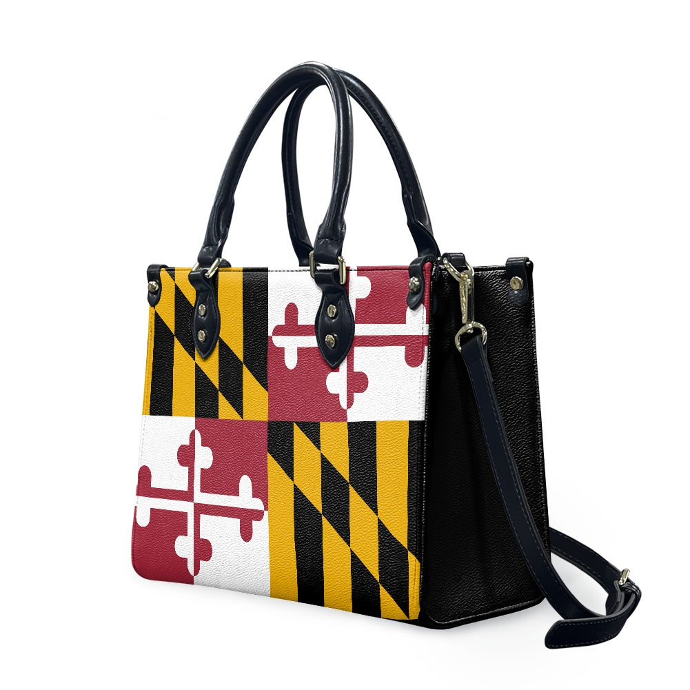 [Brand] handbag with Maryland flag design and black straps.