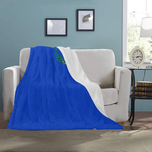 Cozy "Luv My Flag" blanket on a cream sofa.