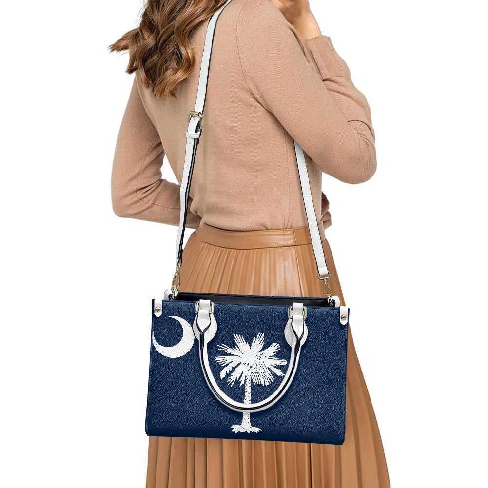 Woman wearing [Brand] handbag featuring palm and crescent design.