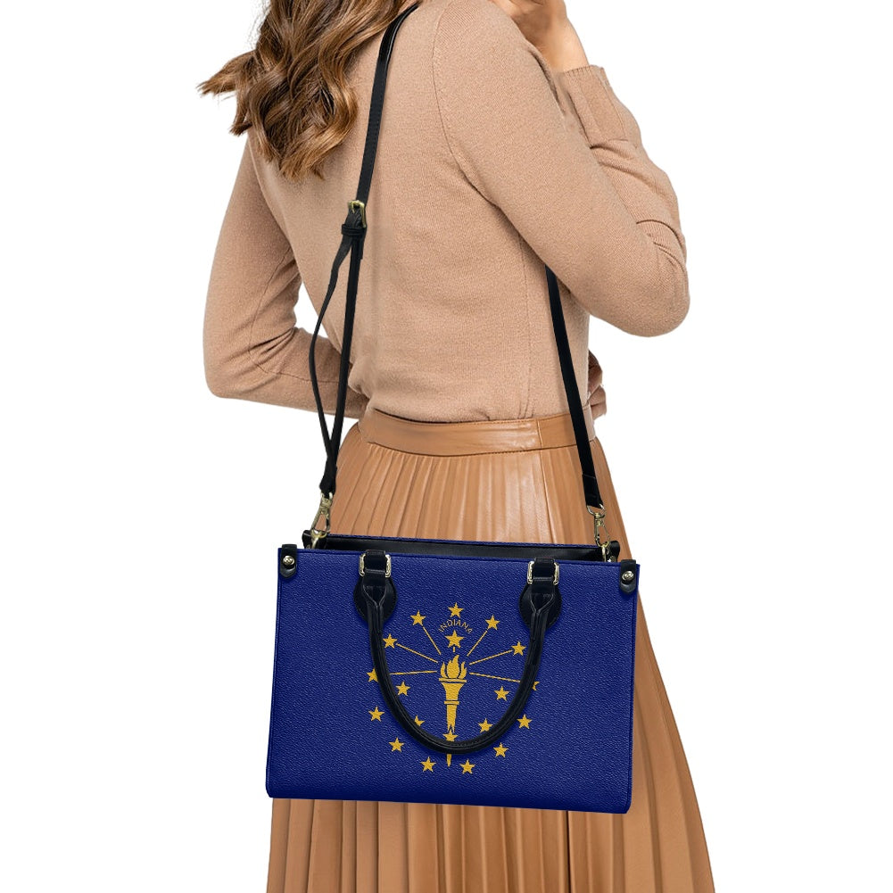 Woman carrying [Brand] blue bag with Indiana flag design.