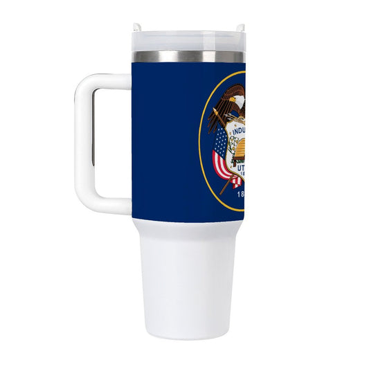 [Brand] travel mug featuring Utah state seal, white handle.
