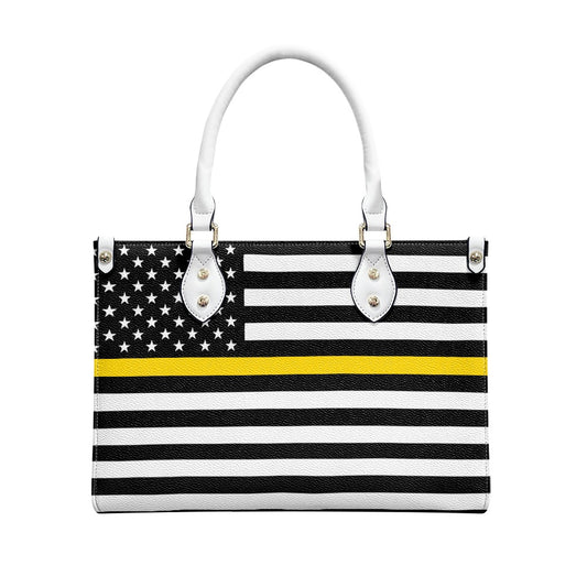[Brand] handbag with black, white, yellow striped design.