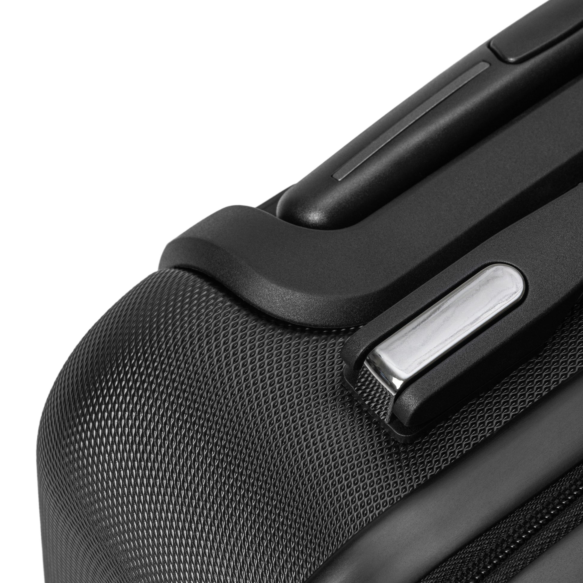 Close-up of [Brand] suitcase corner with textured black finish.