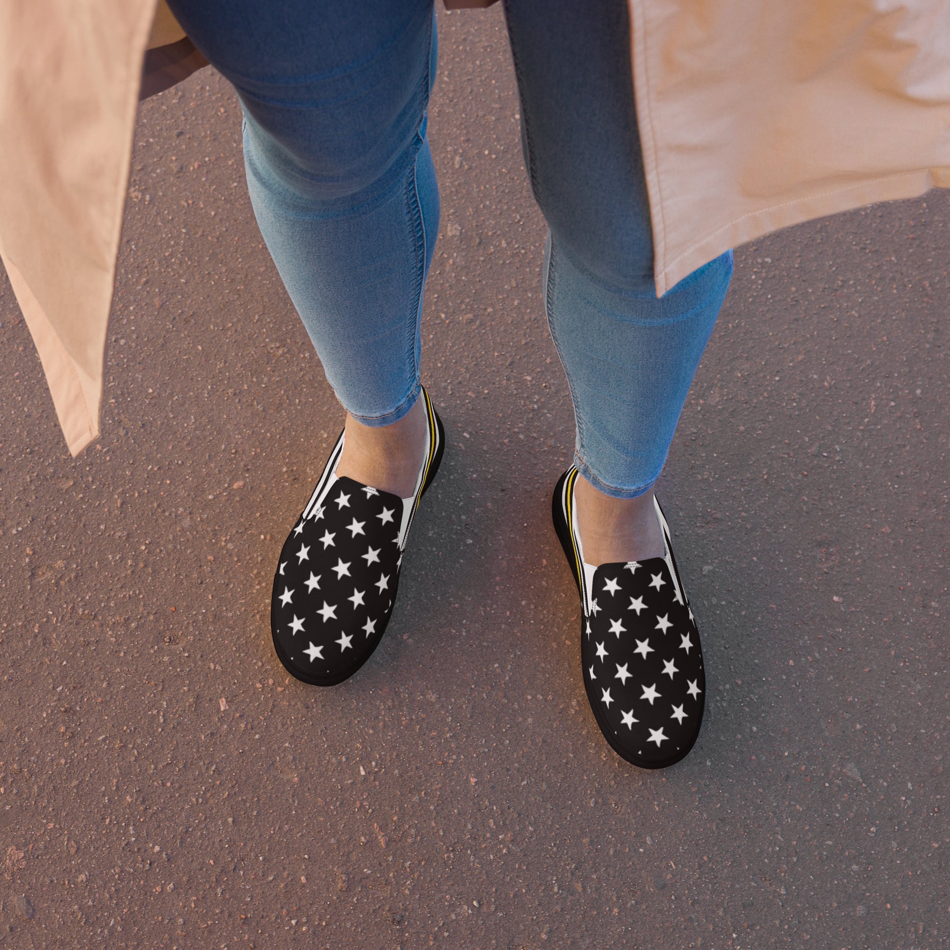 [Brand] star-patterned slip-ons with blue jeans and coat.