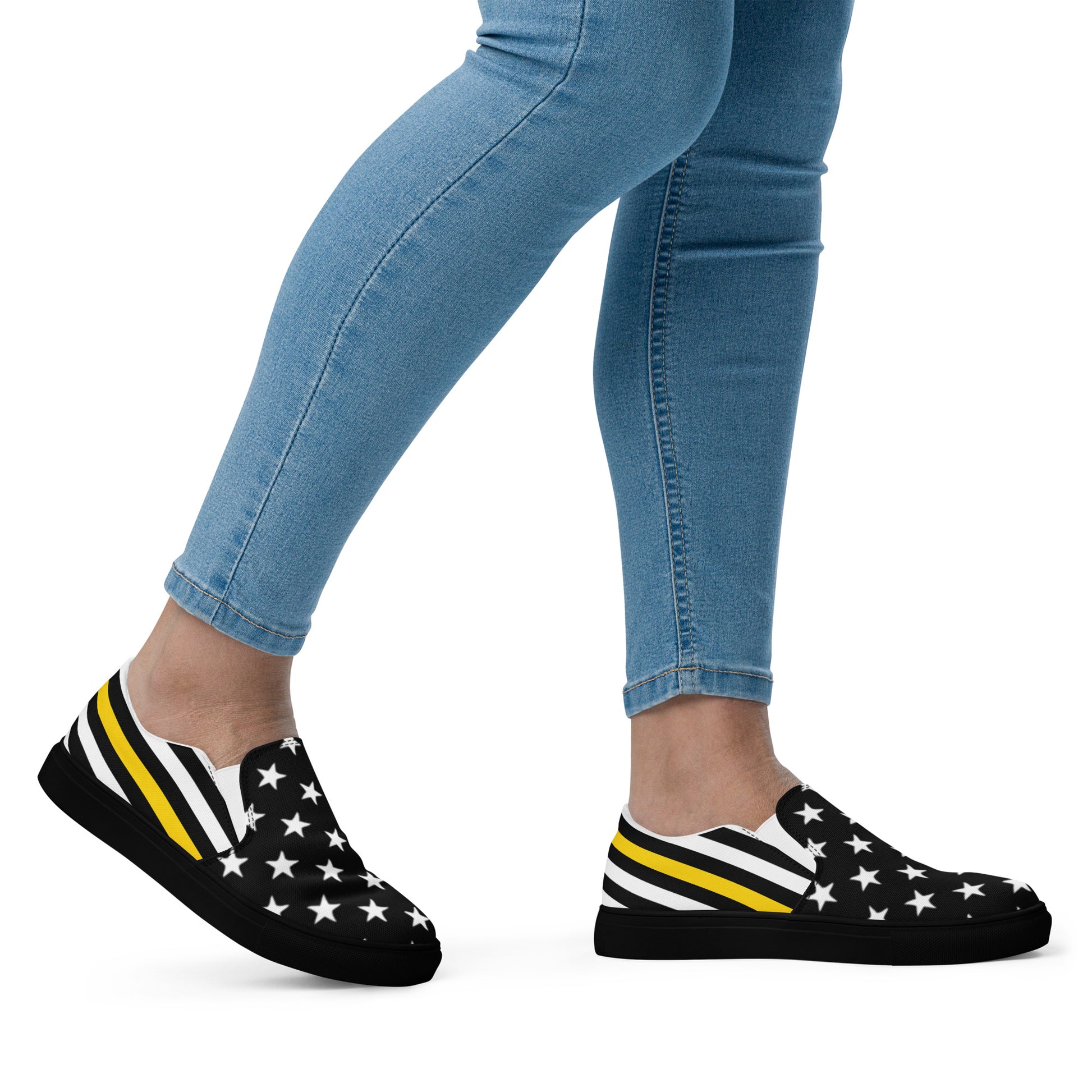 Person wearing [Brand] sneakers, star and stripe pattern, jeans.