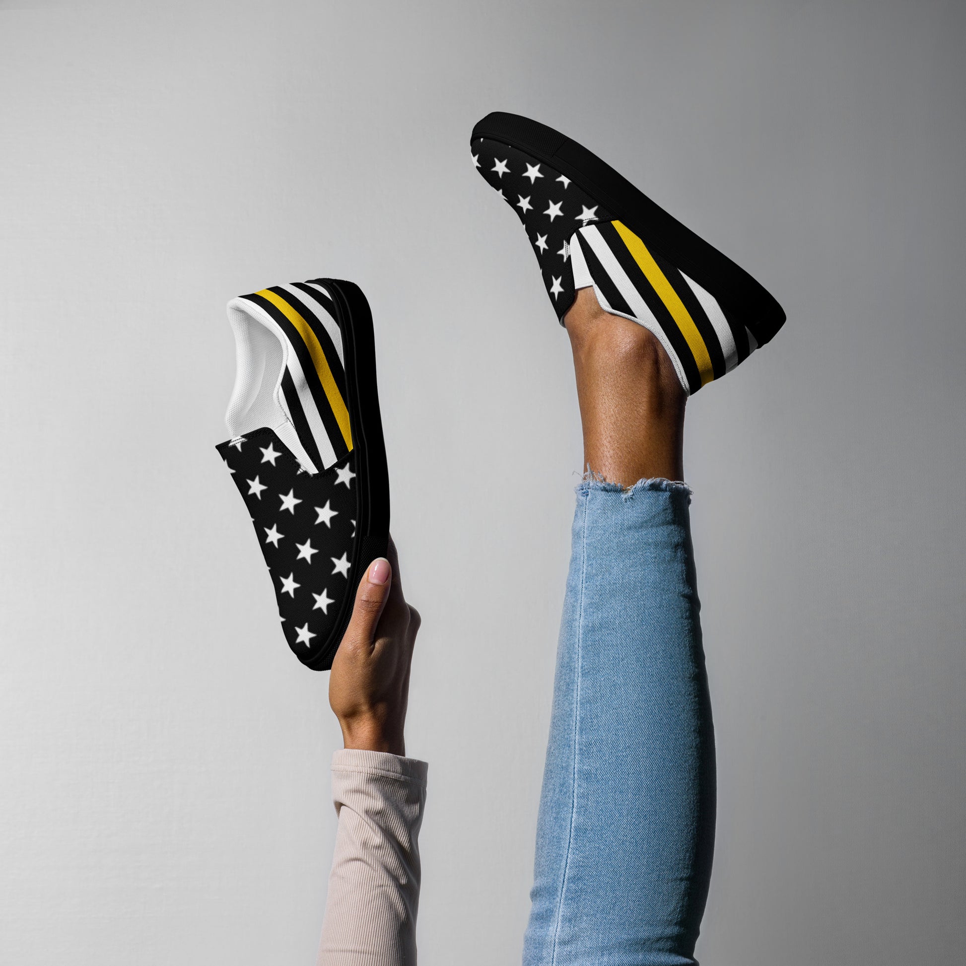 Legs wearing [Brand] shoes with stars and stripes pattern.